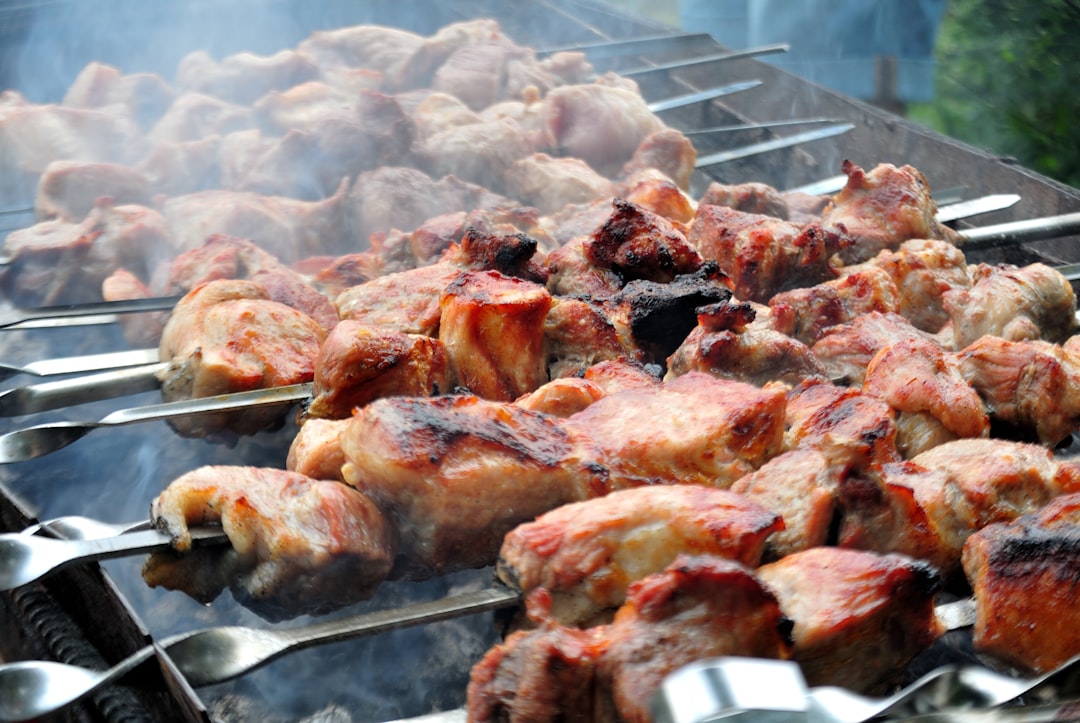 a-bunch-of-meat-is-cooking-on-a-grill-t7ipe8gdnj8